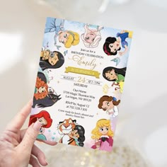 a hand holding up a disney princess birthday party card with all the characters on it