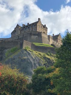 an old castle sitting on top of a hill