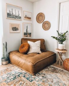 a living room filled with lots of furniture and pictures on the wall above it's couch