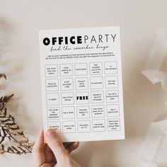 a hand holding up a printable office party game