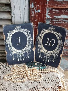 two black and white cards with the number one on them are sitting on a doily