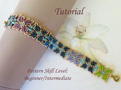 the beaded bracelet is next to a flower