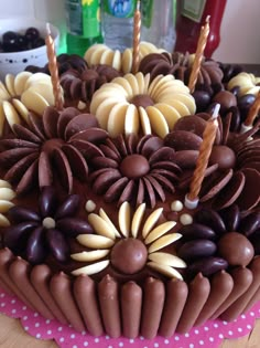 a chocolate cake with flowers and candles on top