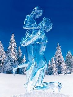 an ice sculpture is in the middle of a snowy landscape with trees and snow flakes