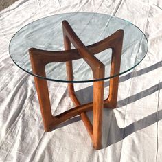 a glass and wood table on a white sheet