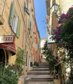 an alleyway with steps leading up to buildings