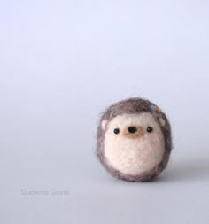 a small stuffed animal sitting on top of a white table