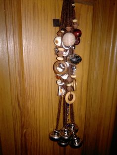 a bunch of different items hanging on a wall next to a wooden paneled door