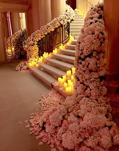 flowers and candles are arranged on the stairs