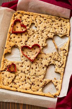 a cookie sheet with cookies and hearts on it