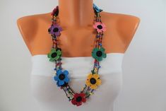 This colorful flower necklace is a rainbow crochet jewelry for women and girls. It is a pretty crochet necklace in our turkish necklaces for women. It is crocheted with organic cotton thread. This multicolor lariat is crocheted with crochet hook. It is completely our own design.   This multistrand pendant is made of cotton thread, beads and crochets. It has 3 strands decorated with multicolor beads. There are large colorful crochets and small multicolor flowers in the necklace which makes this necklace a hippie rainbow necklace.   The measures of the colorful flower necklace are; length 75 cm, height 25 cm and width 15 cm. All connections parts are made of cotton thread. The metal is only used as a clips in this rainbow crochet jewelry. It can be customized in different colors or lengths. Autumn Accessories, Crochet Choker, Multicolor Flowers, Multicolor Necklace, Crochet Jewellery, Choker Necklace Designs, Crochet Jewelry Patterns, Rainbow Crochet, Rainbow Necklace