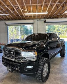 a large black truck parked in a garage