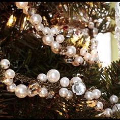 a christmas tree decorated with pearls and lights