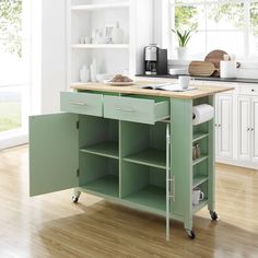 a green kitchen island with drawers on wheels