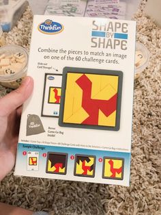 someone is holding up a box of shape by shape game