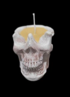 a candle with a skull on it is in the shape of a human's head