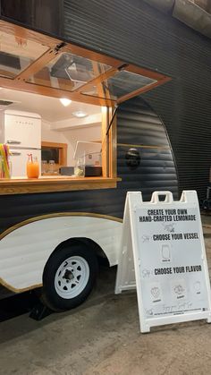 a food truck with a sign next to it