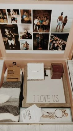 an open suitcase filled with personal items and pictures on the wall behind it that says, i love us