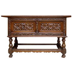 an old wooden table with carvings on the top and bottom shelf, against a white background