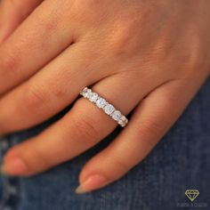 a woman's hand with a diamond ring on it