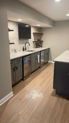 a kitchen with wood floors and stainless steel appliances