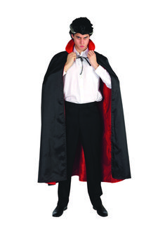 a man dressed in a dracula costume with cape and black pants, posing for the camera