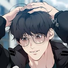 a young man with glasses is posing for the camera and has his hands on his head