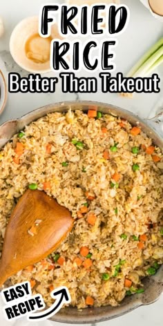 fried rice is better than takeout in a skillet with a wooden spoon on the side