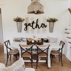 a dining room table and chairs with the word eat on it's wall above them