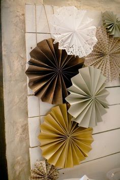 several paper fans are hanging on the wall