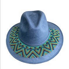 Suede Cowgirl Hat With Chaquira Beaded Hat Band. The Hat Band Is Removable, Ties To Adjust. It Can Also Be Use As A Necklace. Sweatband On Hat Makes It More Comfortable To Wear. Includes Hat And Hat Band. Size-Medium Handmade In Chiapas Mexico. Blue Fedora Felt Hat For Festivals, Blue Adjustable Felt Hat With Short Brim, Blue Brimmed Felt Hat For Festival, Blue Wide Brim Felt Hat For Festivals, Blue Felt Hat With Flat Brim For Festivals, Blue Flat Brim Felt Hat For Festival, Blue Fedora With Curved Brim For Festival, Bohemian Blue Felt Hat With Short Brim, Blue Bohemian Felt Hat With Short Brim