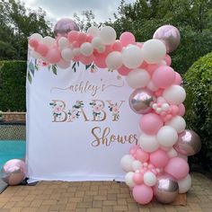 an outdoor baby shower with balloons and streamers