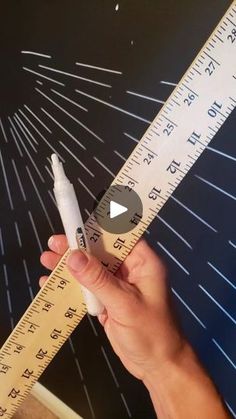 someone is measuring their height with a tape measure ruler and an eraser in front of them