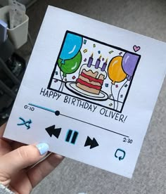 a person holding up a birthday card with balloons and a cake in the background that says happy birthday silver