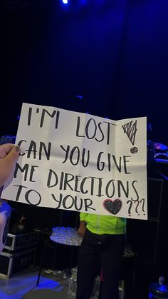 someone holding up a sign that says i'm lost can you give me directions to your?