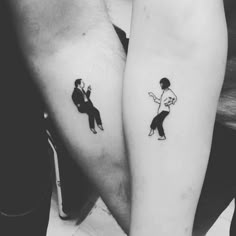 two people with matching tattoos on their arms, one has a man and the other is a woman