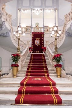 a red carpeted staircase leading up to the first floor