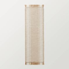 a beige wall hanging on the side of a white wall