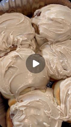 a bowl filled with frosted donuts sitting on top of a table