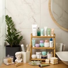 a wooden shelf filled with cosmetics next to a bath tub