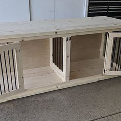 a dog house made out of pallets and wooden crates with doors open on the side