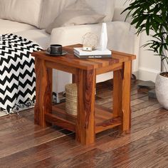 a wooden table sitting on top of a hard wood floor next to a white couch