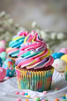 cupcakes with colorful frosting and sprinkles on a white plate