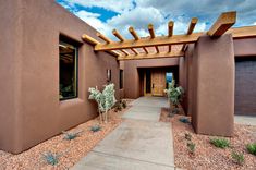 an adobe - style home in the desert with cactus and cacti