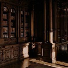 an old library with many bookshelves and wooden cabinets in the sun shining on the floor