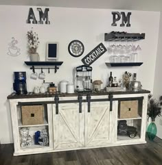 a room with some shelves filled with bottles and glasses on top of each shelf in front of a clock