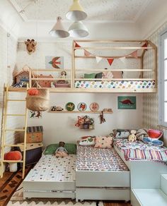 a child's bedroom with bunk beds and toys on the shelves above them,