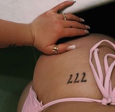 a woman's stomach with the number 22 tattooed on it