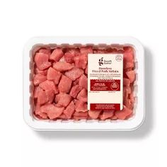 raw diced meat in a plastic container on a white background with the label above it