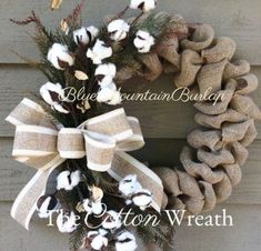 the cotton wreath is hanging on the door